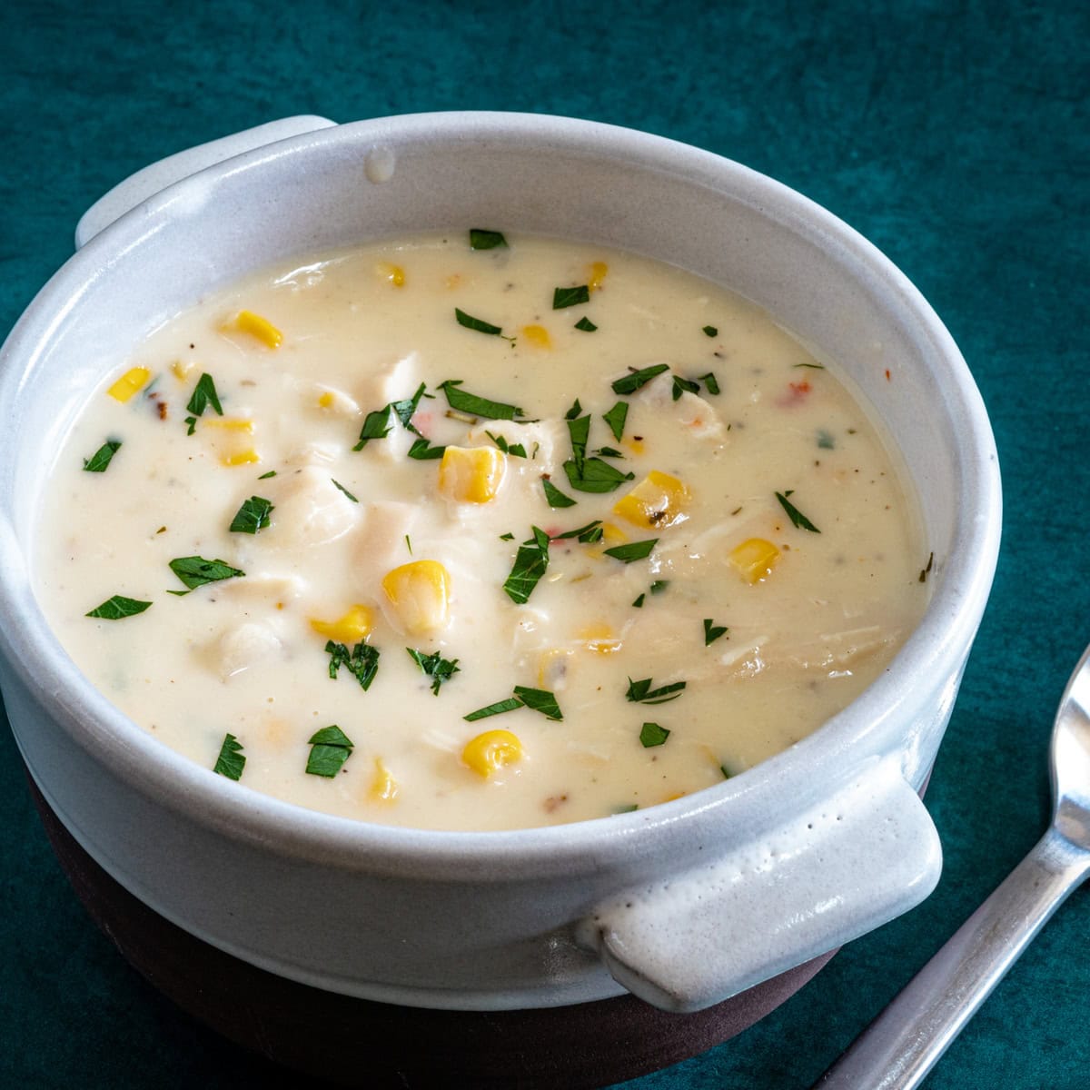 Chicken chowder in a bowl with parsley garnish.