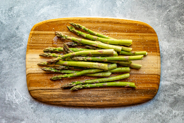 Fresh green asparagus on wooden board.