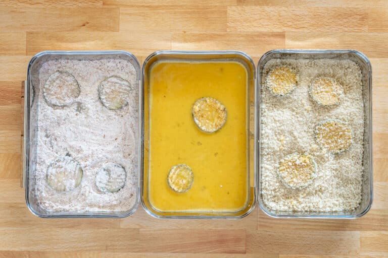 Breading the dill pickle slices in seasoned flour, egg, and panko crumbs.