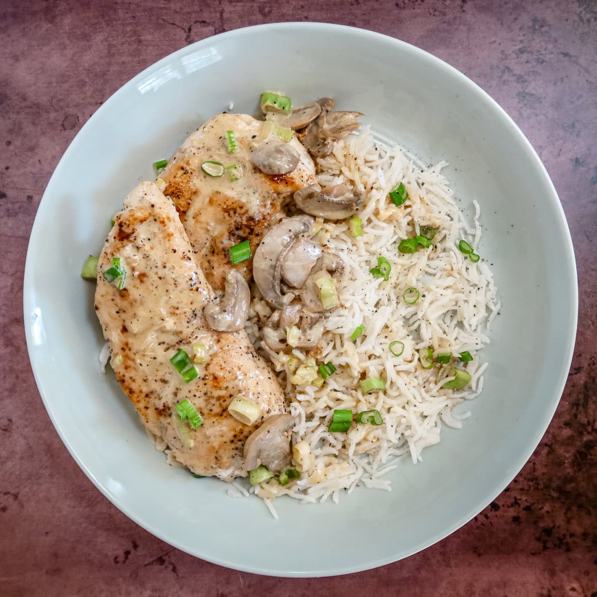 A serving of apple brandy chicken on rice.