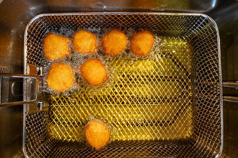 Pumpkin fritters in the deep fryer.