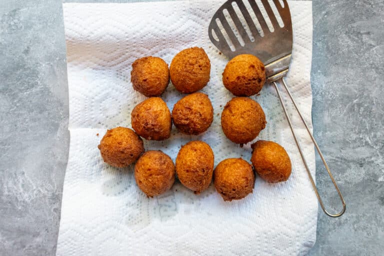 Pumpkin fritters draining on paper towels.