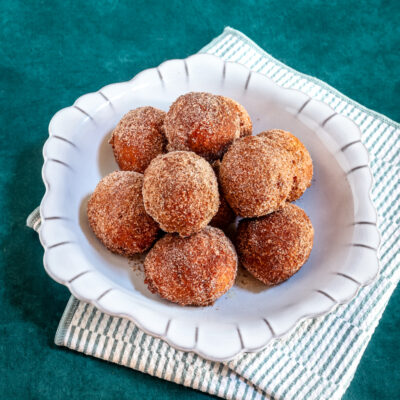 Pumpkin fritters in a gray dish.