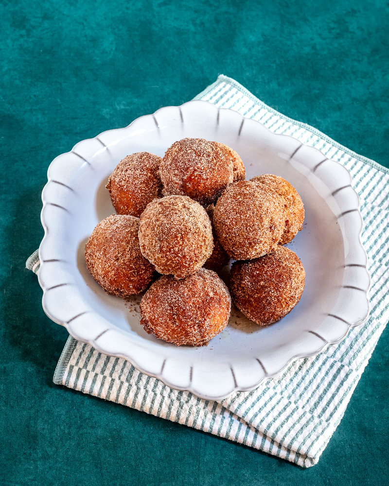 Pumpkin fritters in a gray dish.