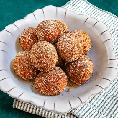 A dish of cinnamon sugar-coated pumpkin fritters.