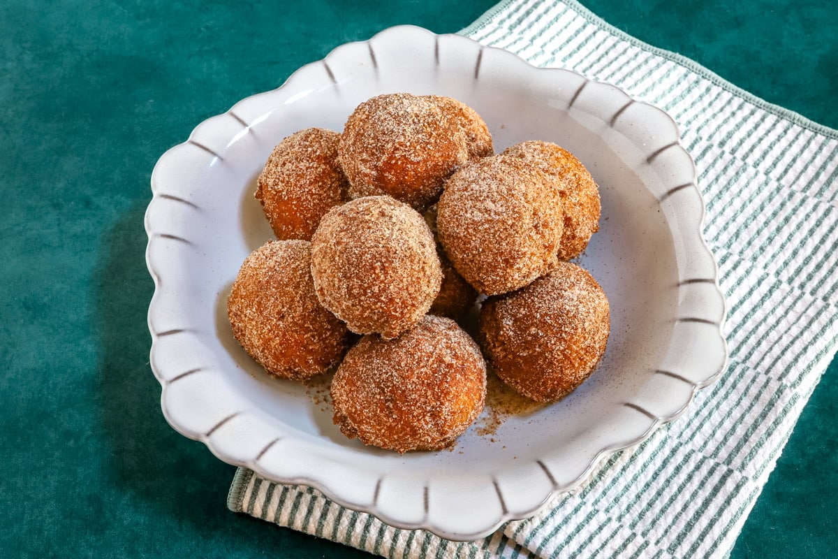 A dish of cinnamon sugar-coated pumpkin fritters.