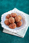 A dish of cinnamon sugar-coated pumpkin fritters.