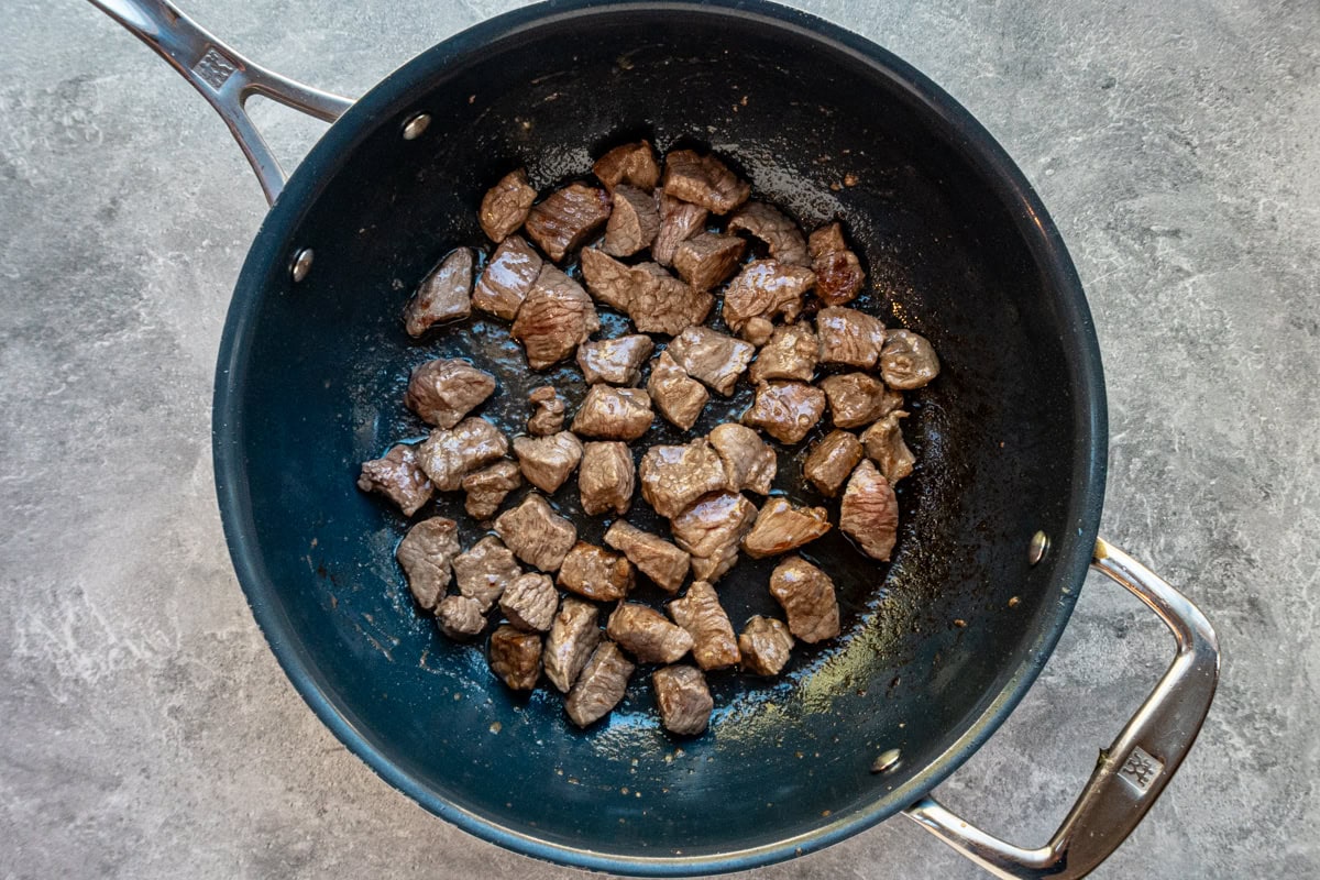 Browning beef cubes for skillet beef Burgundy.