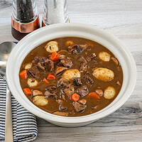Beef stew with carrots, potatoes, and mushrooms in a rich brown gravy.