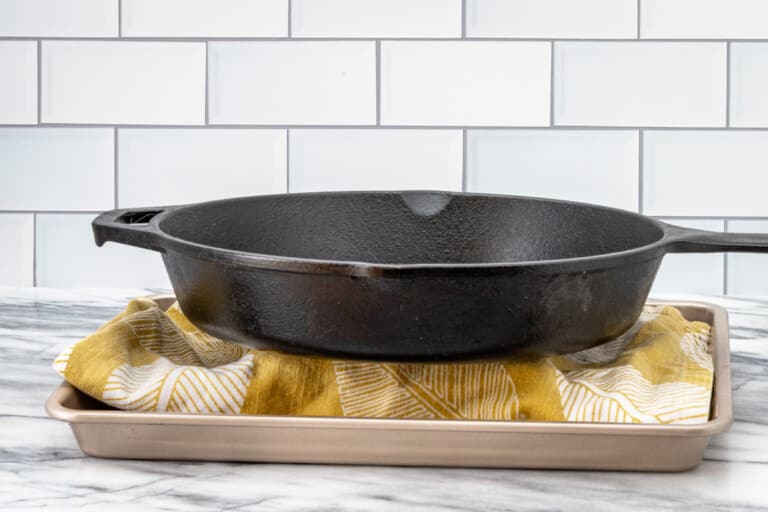 Pressing the tofu using a heavy iron skillet.