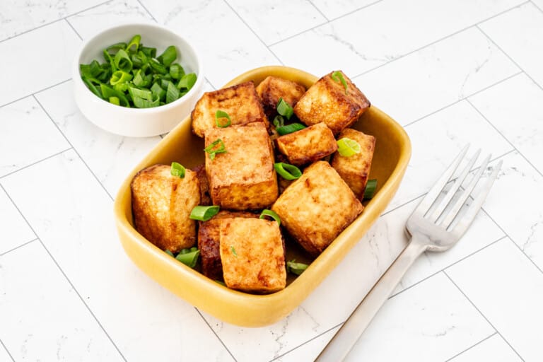 The tofu in a small dish with green onions for garnish.