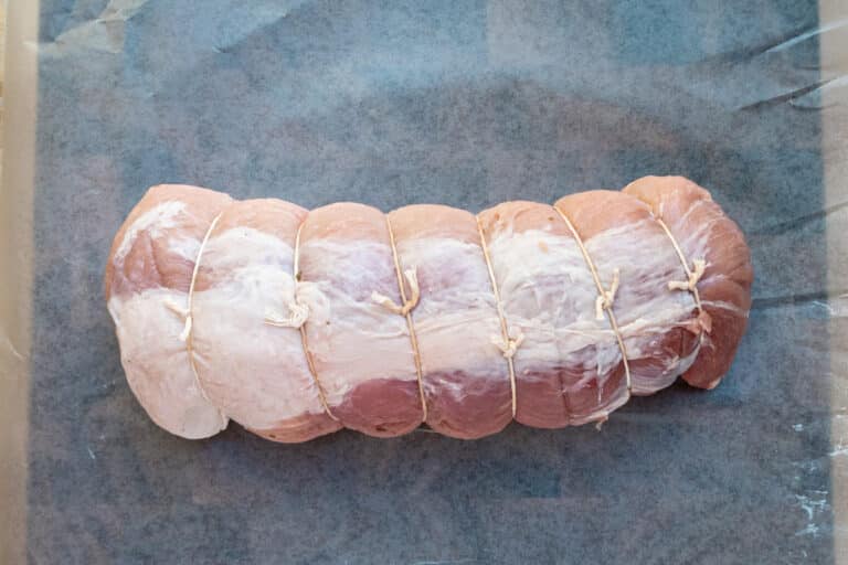 Tied pork roast that has been stuffed with a mixture of apples, cranberries, and sage.