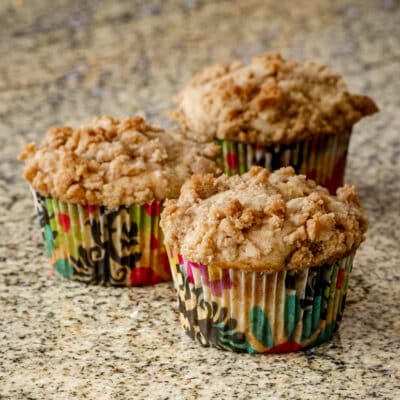 A batch of baked apple crumble muffins.