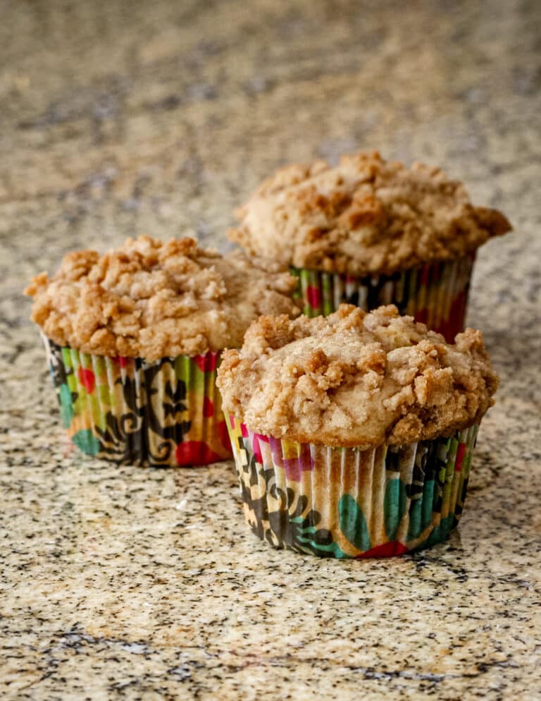 A batch of baked apple crumble muffins.