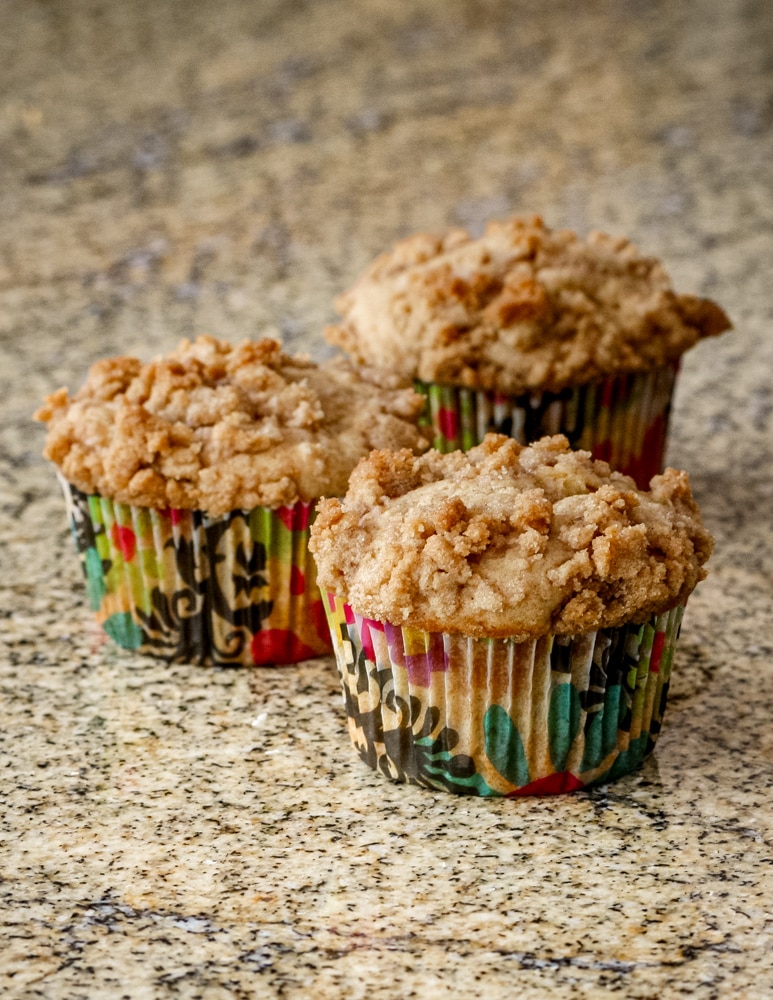 A batch of baked apple crumble muffins.