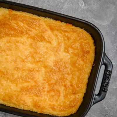 Southern cheese grits with garlic in a baking dish.