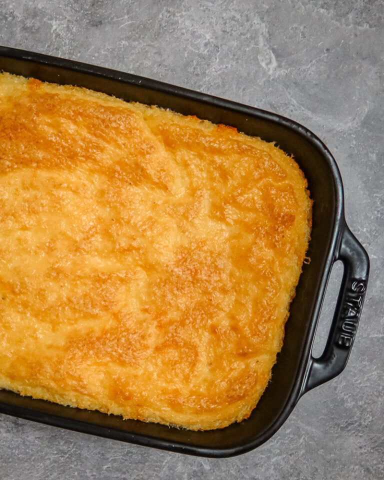 Southern cheese grits with garlic in a baking dish.