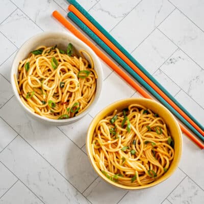 Two small bowls of chili garlic noodles.
