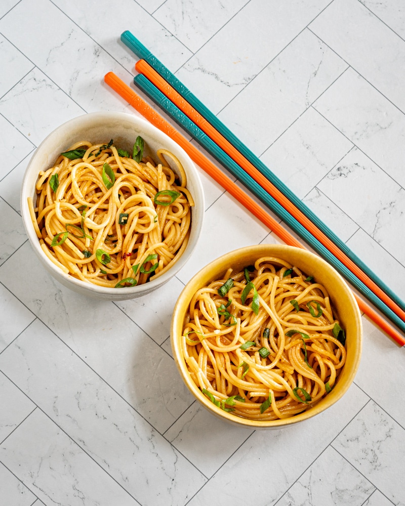 Two small bowls of chili garlic noodles.