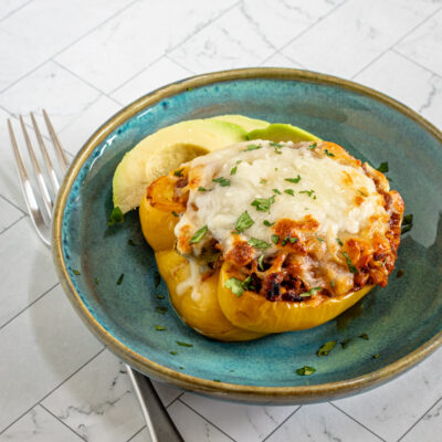 Chorizo stuffed peppers with cheese topping.
