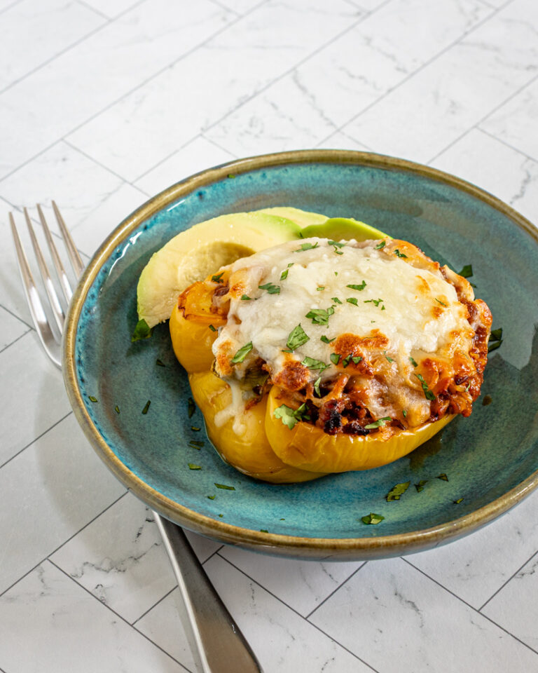 Chorizo stuffed peppers with cheese topping.