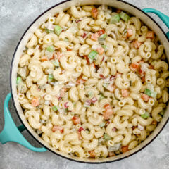 A creamy, flavorful macaroni salad in a Dansk pot for serving.