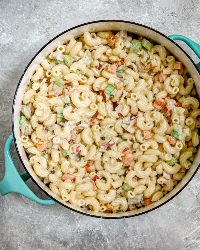 A creamy, flavorful macaroni salad in a Dansk pot for serving.