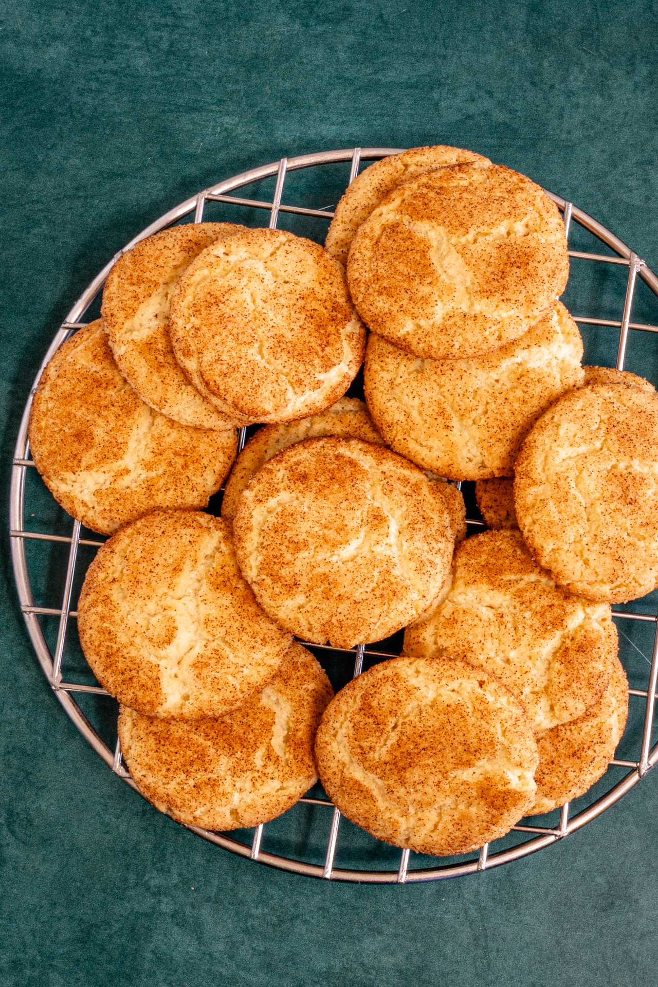 Snickerdoodle cookies on a cooling rack.
