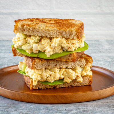 Egg salad on toasted bread with lettuce.