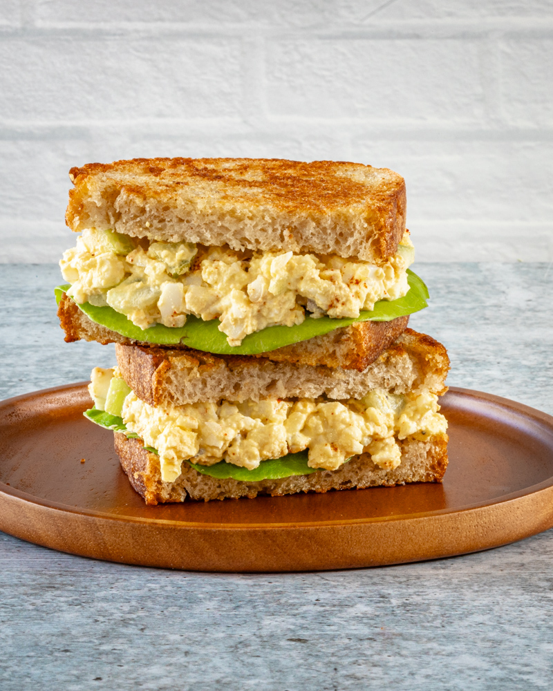 Egg salad on toasted bread with lettuce.