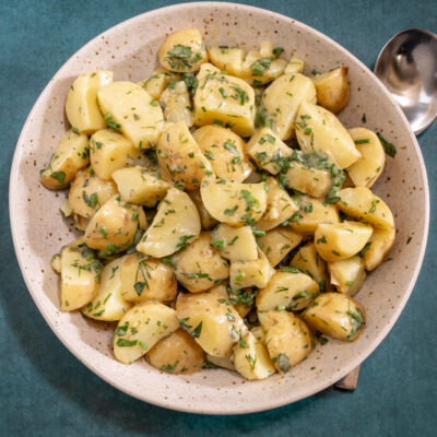 A French style potato salad in a large serving bowl.