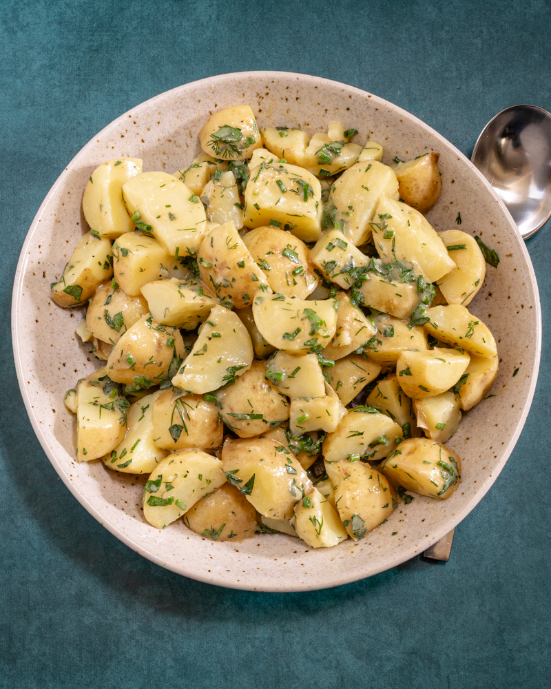A French style potato salad in a large serving bowl.