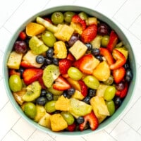A fresh fruit salad in a large serving bowl.