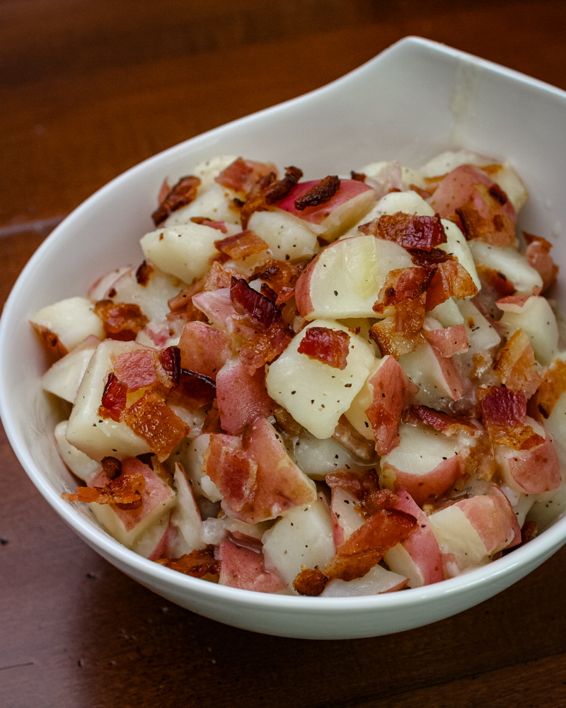 A serving bowl of German potato salad.