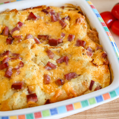 A breakfast casserole with ham and eggs.