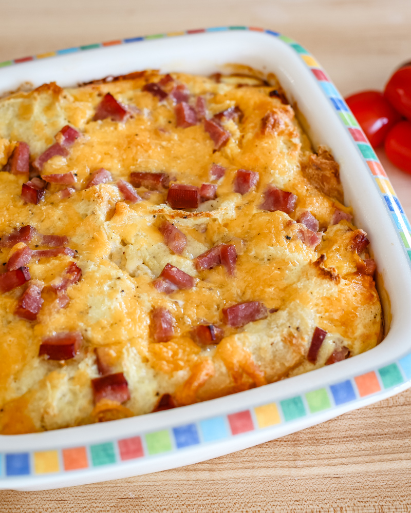 A breakfast casserole with ham and eggs.