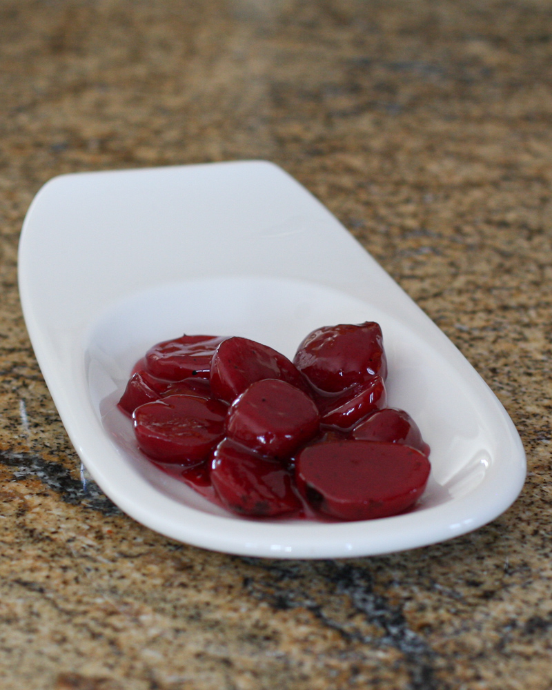 Sweet and sour Harvard beets on a small plate.