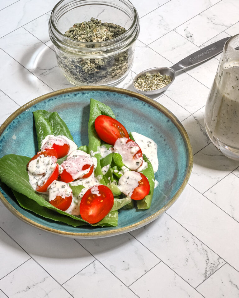 Homemade buttermilk ranch dressing on a small salad with the dry mix on the side.