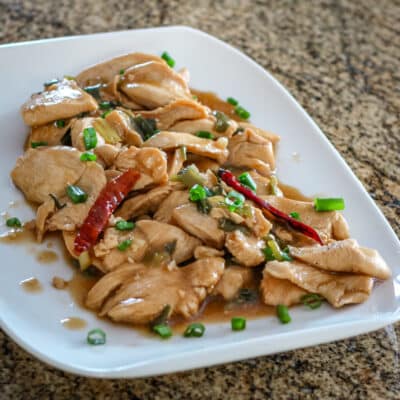A platter of Hunan chicken with hot red peppers.