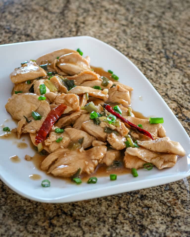 A platter of Hunan chicken with hot red peppers.