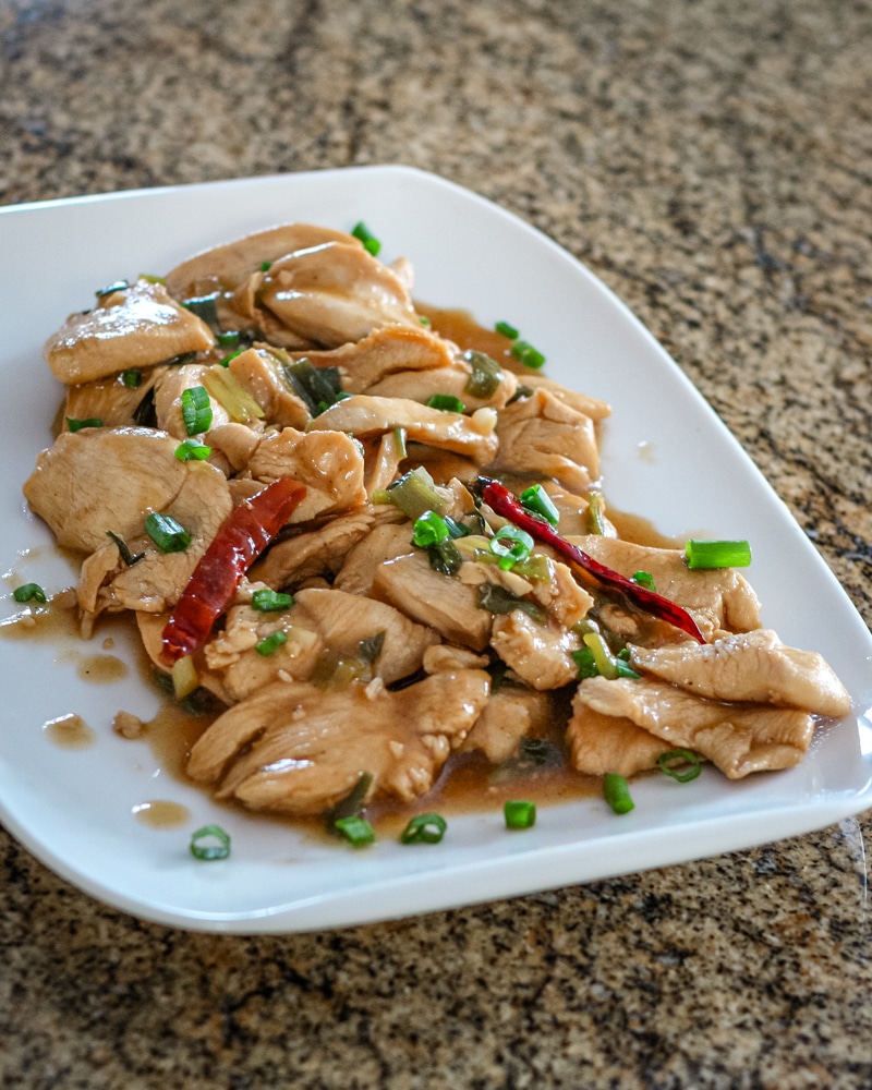 A platter of Hunan chicken with hot red peppers.