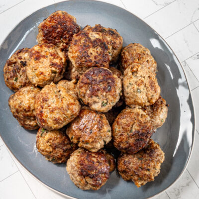 Meatballs on a blue serving tray.