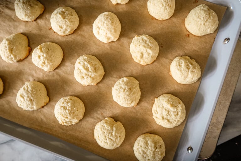 Ricotta cookies on a cookie sheet.