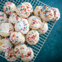 Iced ricotta cookies on a cooling rack.
