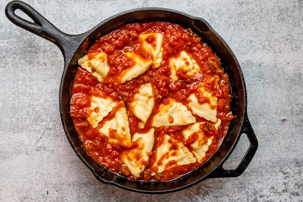 Ravioli layered in the meat sauce for a lazy skillet lasagna.