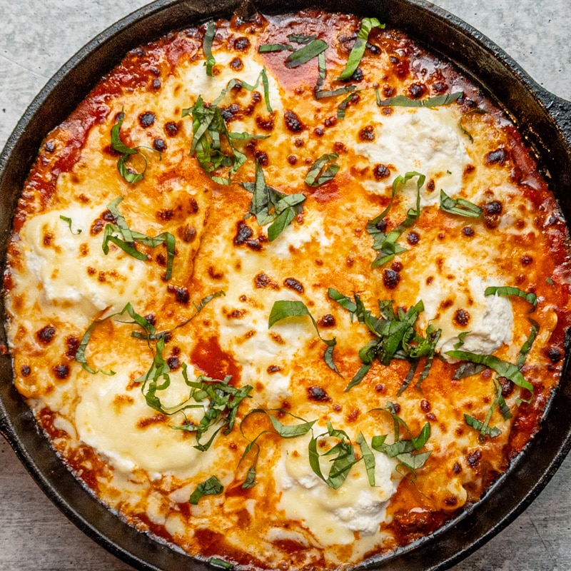A quick and easy skillet lasagna with ricotta cheese and basil garnish.
