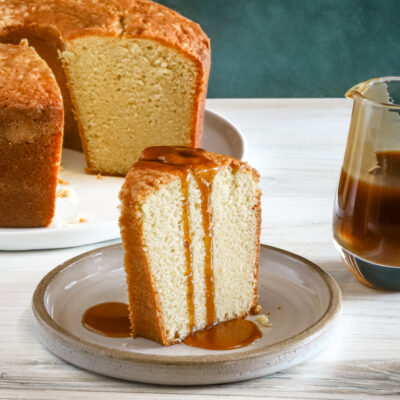 A slice of million dollar pound cake, a buttermilk pound cake with a caramel sauce drizzle.