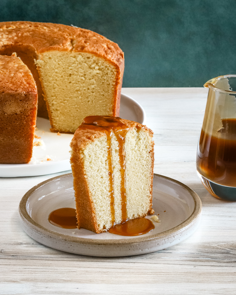 A slice of million dollar pound cake, a buttermilk pound cake with a caramel sauce drizzle.