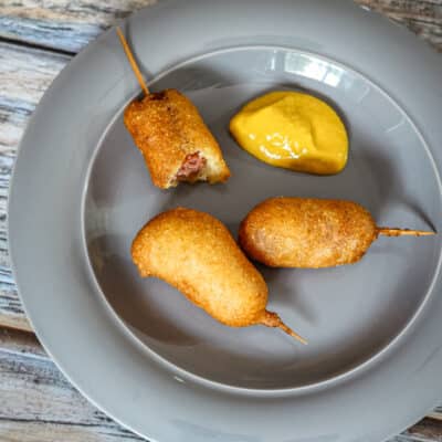 A plate of appetizer mini corn dogs.