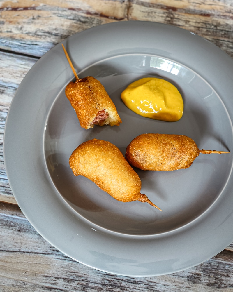 A plate of appetizer mini corn dogs.